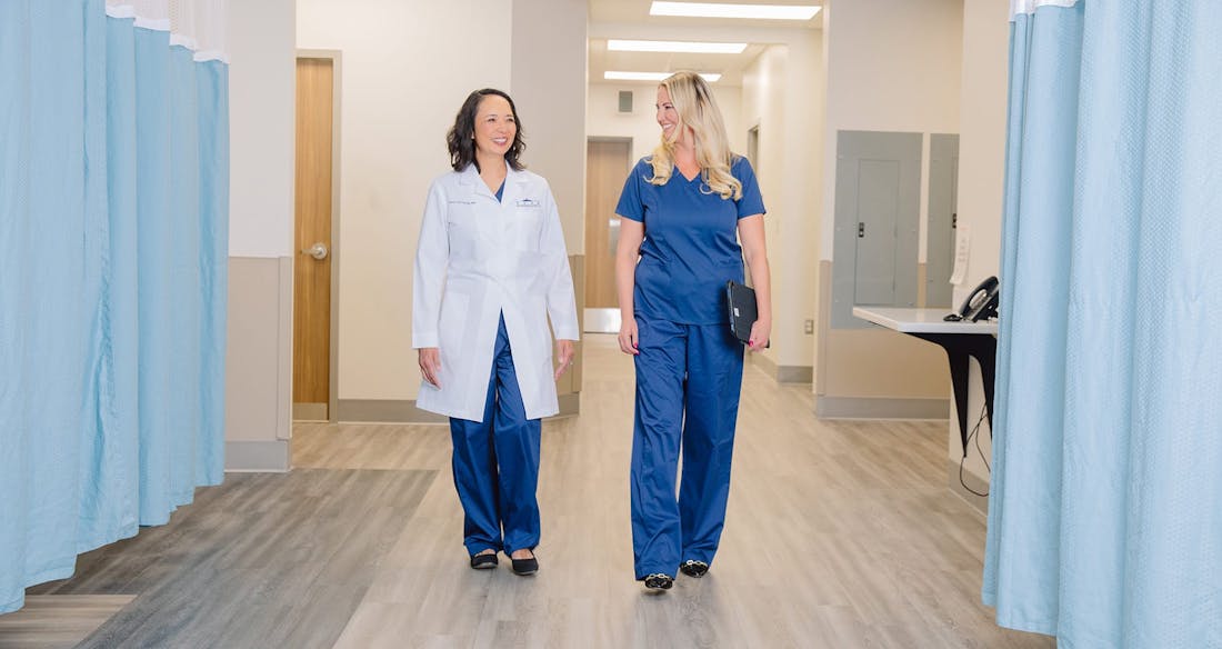 two doctors walking down an isle