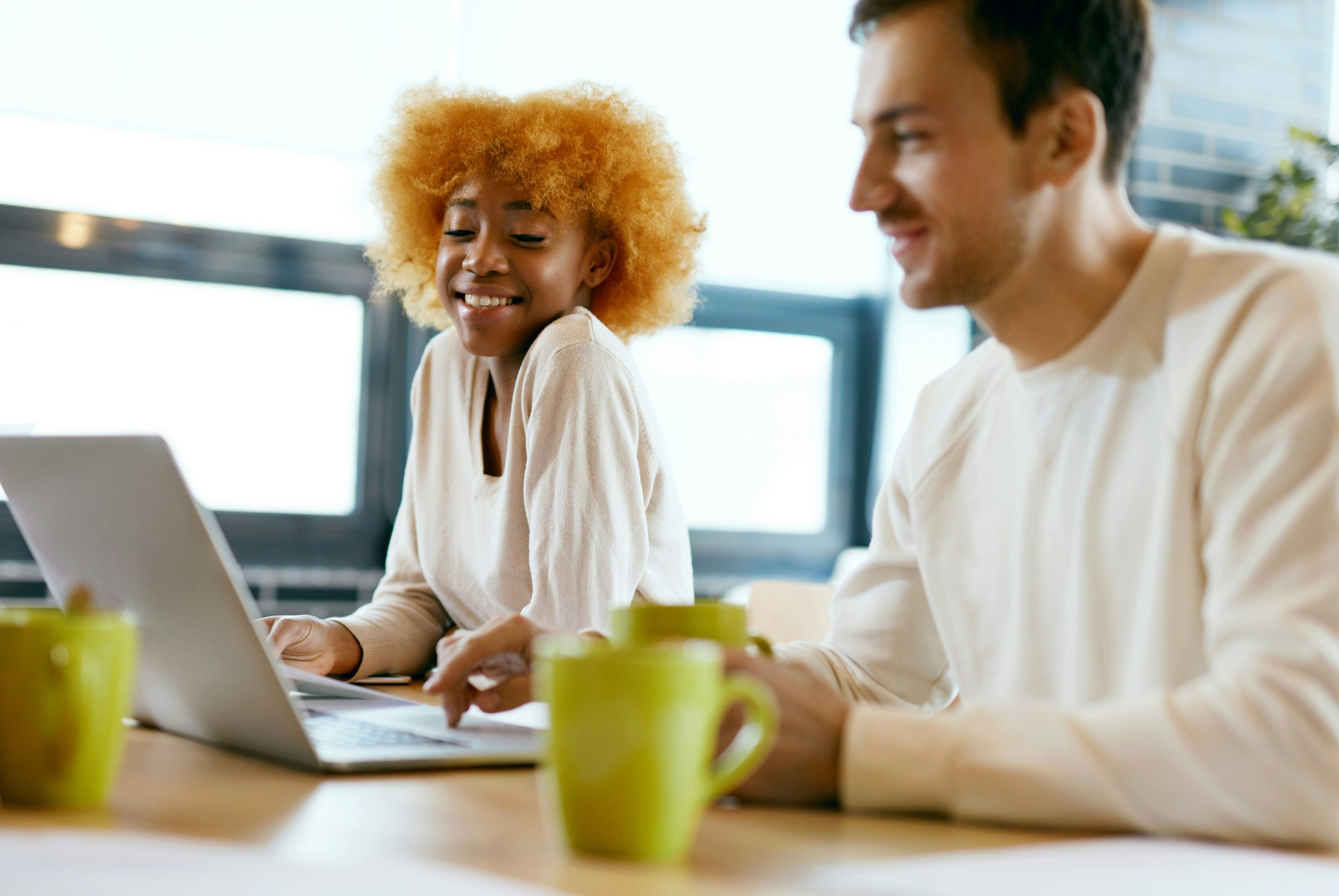 Two happy people looking at a laptop