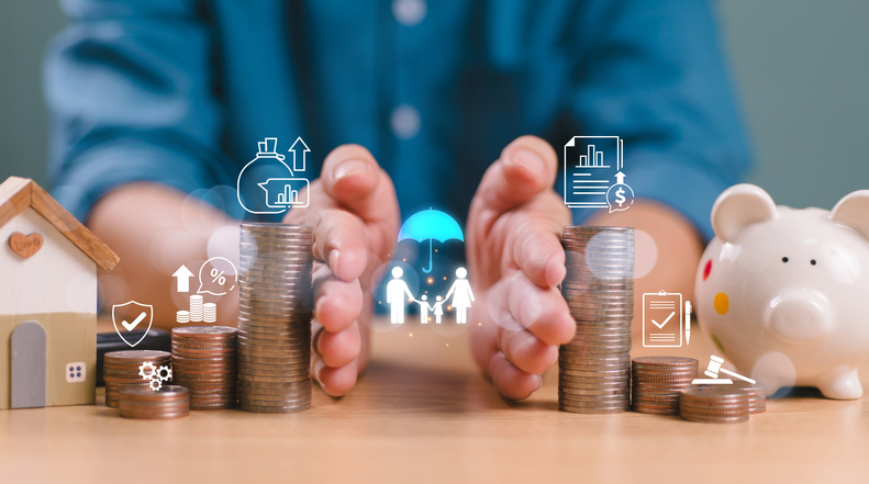 A person with 2 hands separating the coins, house, piggy bank and others to show the protection of the assets.