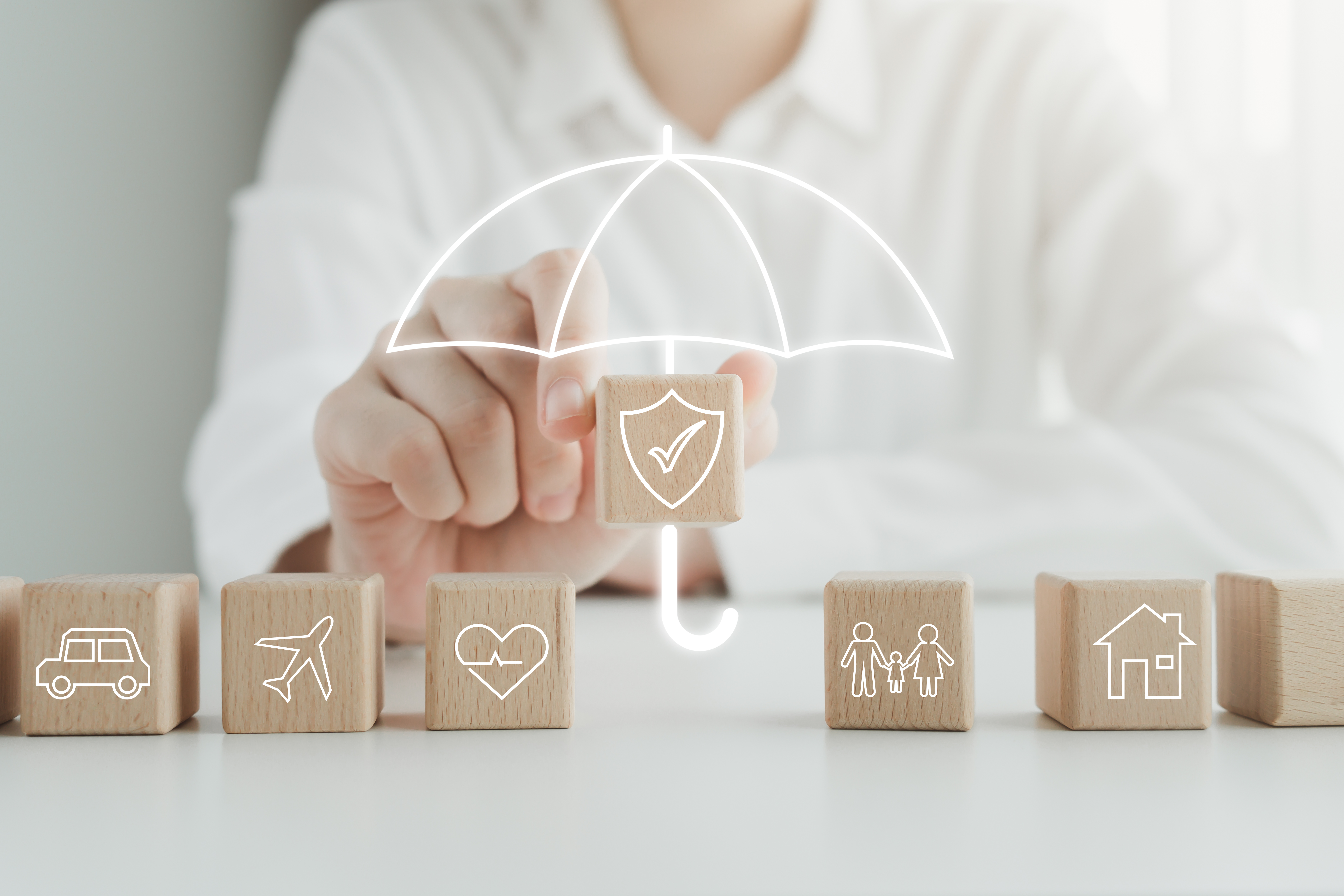 Car, airplane, heart or health, family, house under the umbrella-represents insurance.