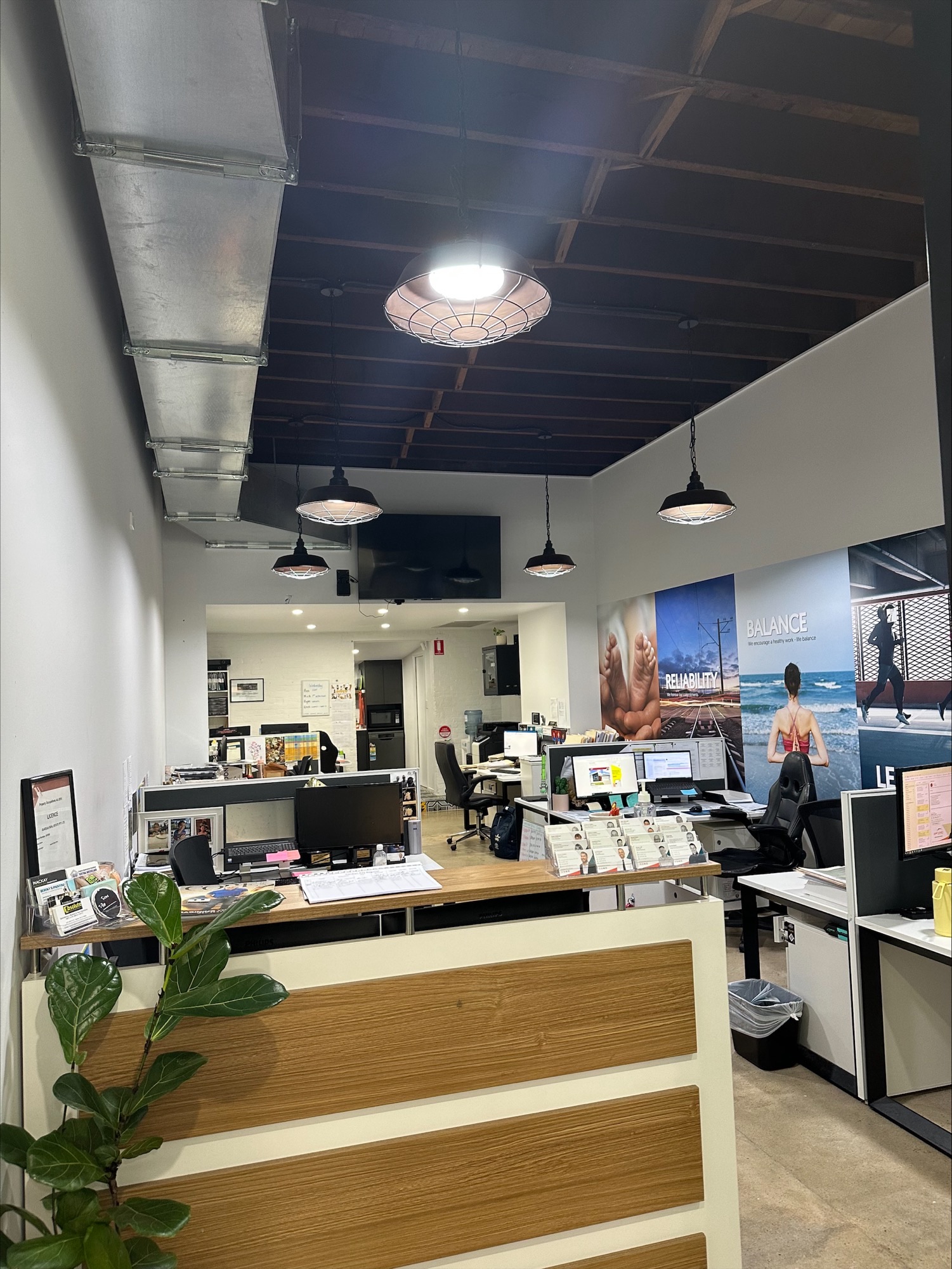 Gardian Real Estate Sales Office with Our Values on the background.