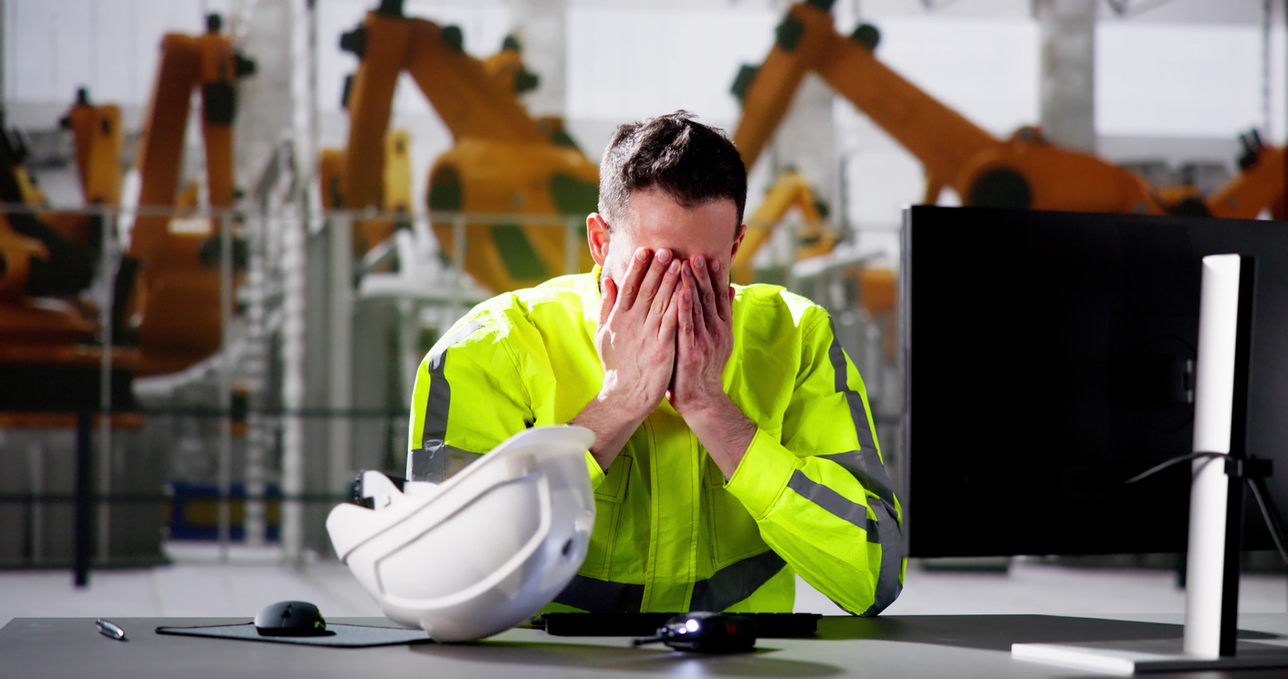 A man covering his face with his two hands due to trauma.