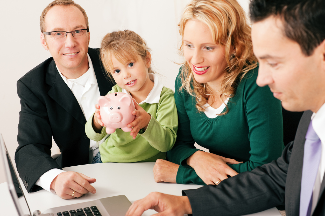 A kid holding a piggy bank joining the parents with financial planning.