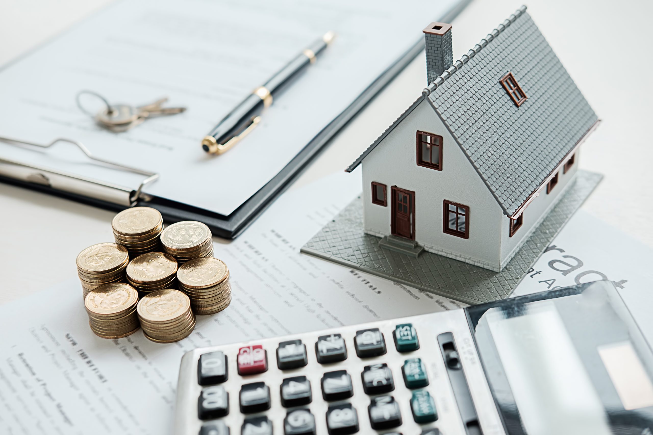 House, coins, calculator, key, pen and paper needed for planning for home loan