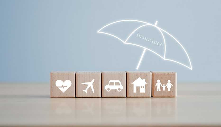 5 woods with photos on each - heart, airplane, car, house, family - all under the umbrella with insurance written on it.