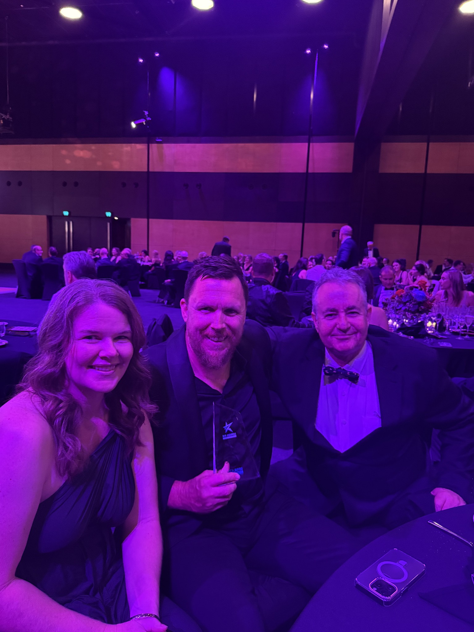Luke Phillips holding the plaque of RIN Connecting in the Community Award.