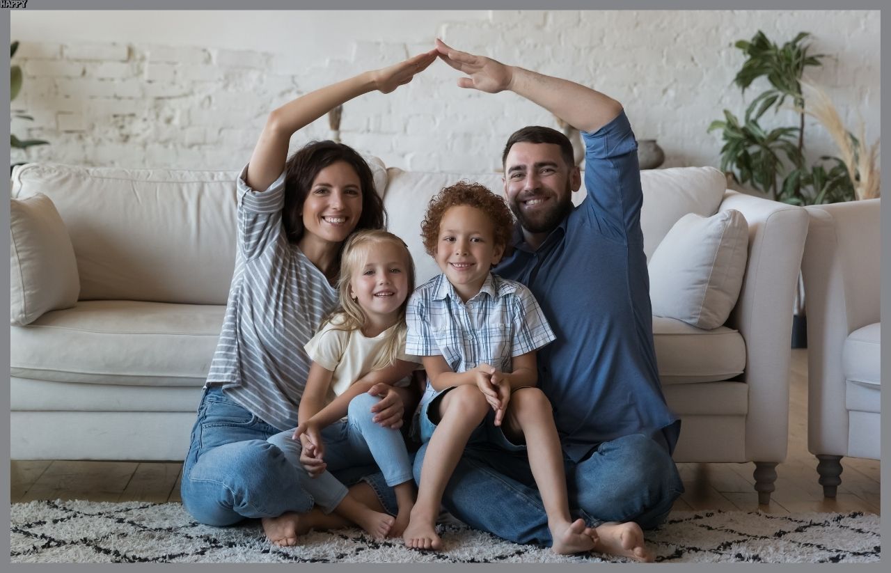 Dad and mum forming a roof on top of their family where they have 2 kids.