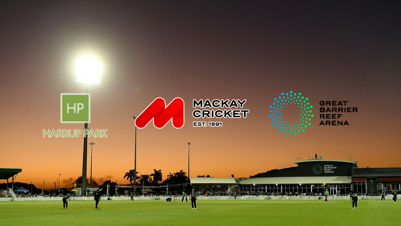 Cricket match at Harrup Park in Mackay, Queensland, with logos of Mackay Cricket, Harrup Park, and Great Barrier Reef Arena displayed against a sunset backdrop.