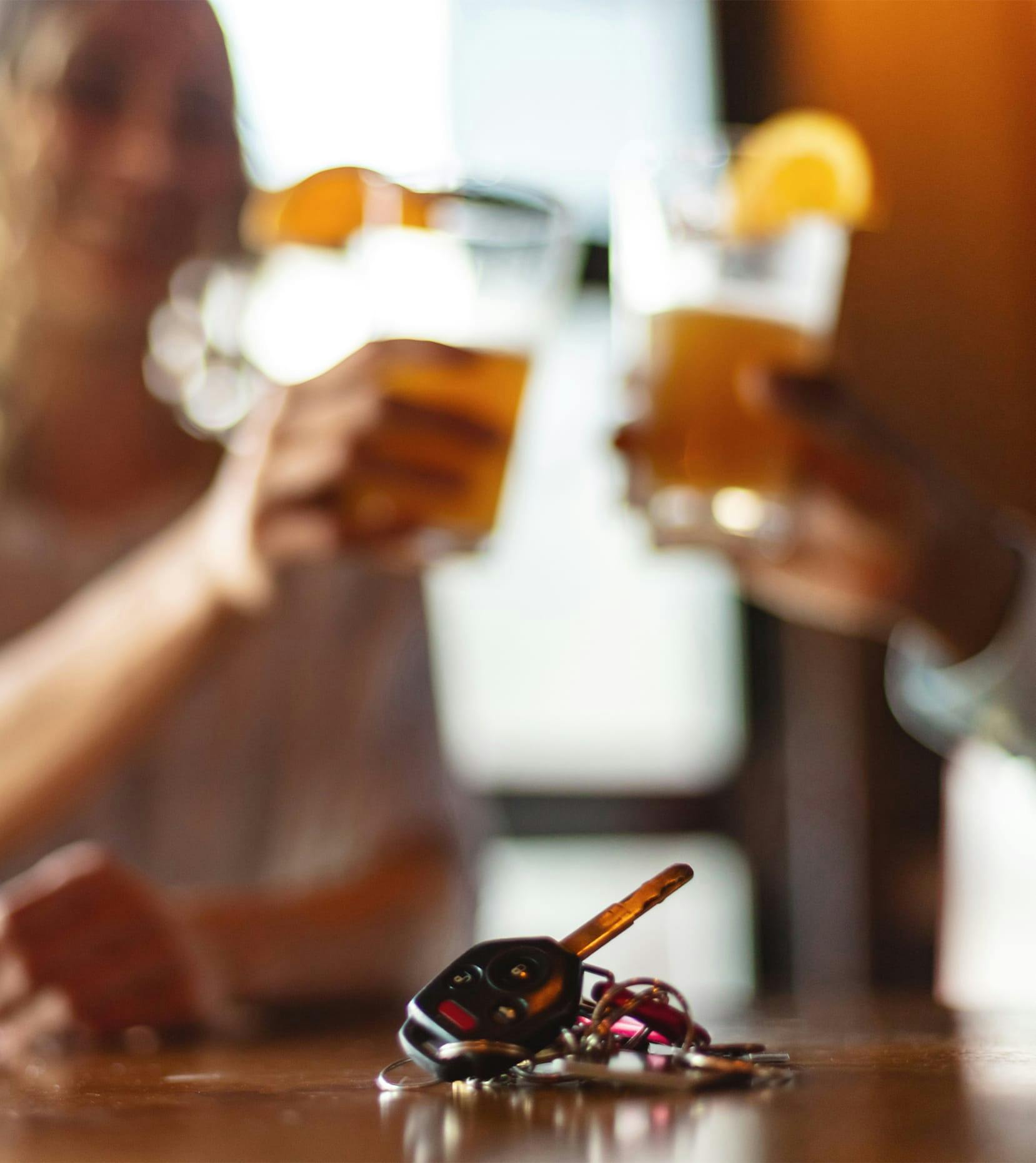 car keys on bar with drinking in the background