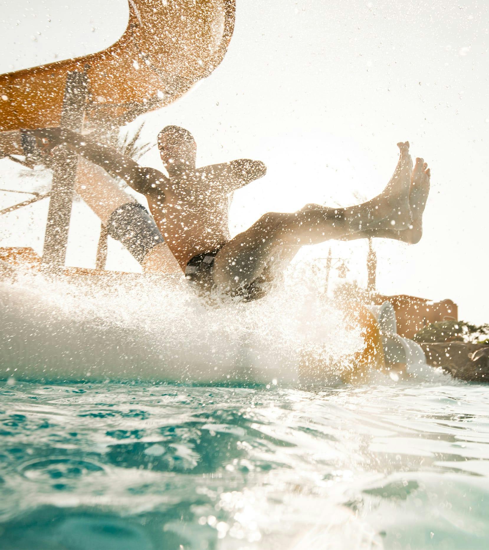 man exiting water slide