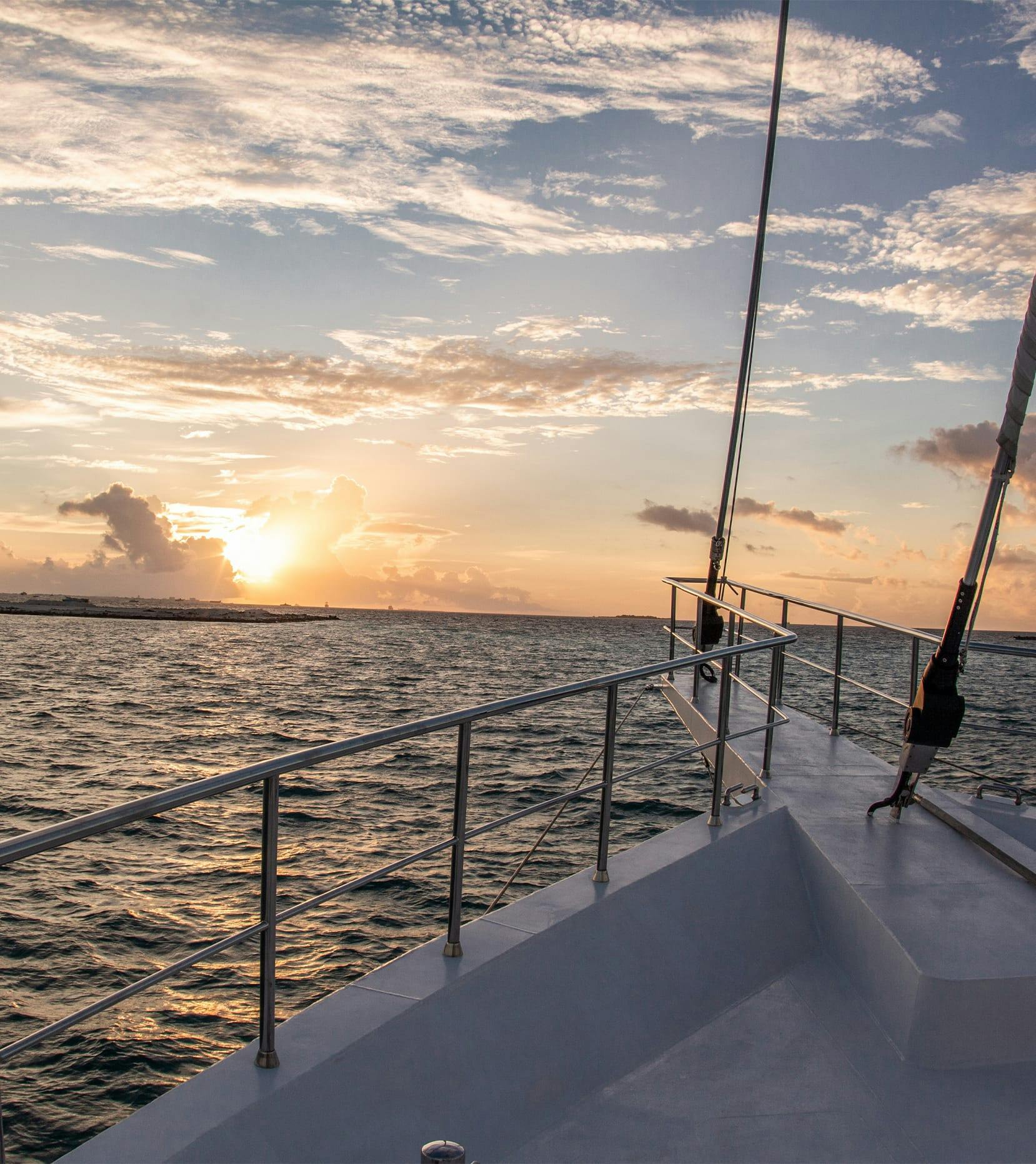 bow of boat in ocean at sunset