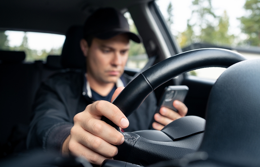 man texting while driving