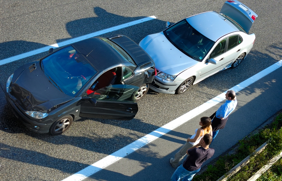 bystanders standing near car accident