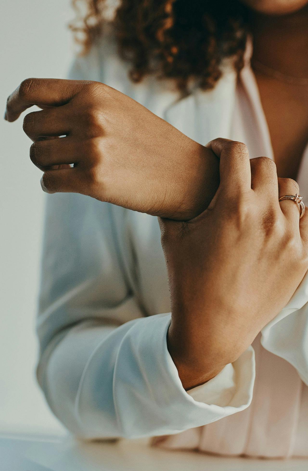 woman holding arm