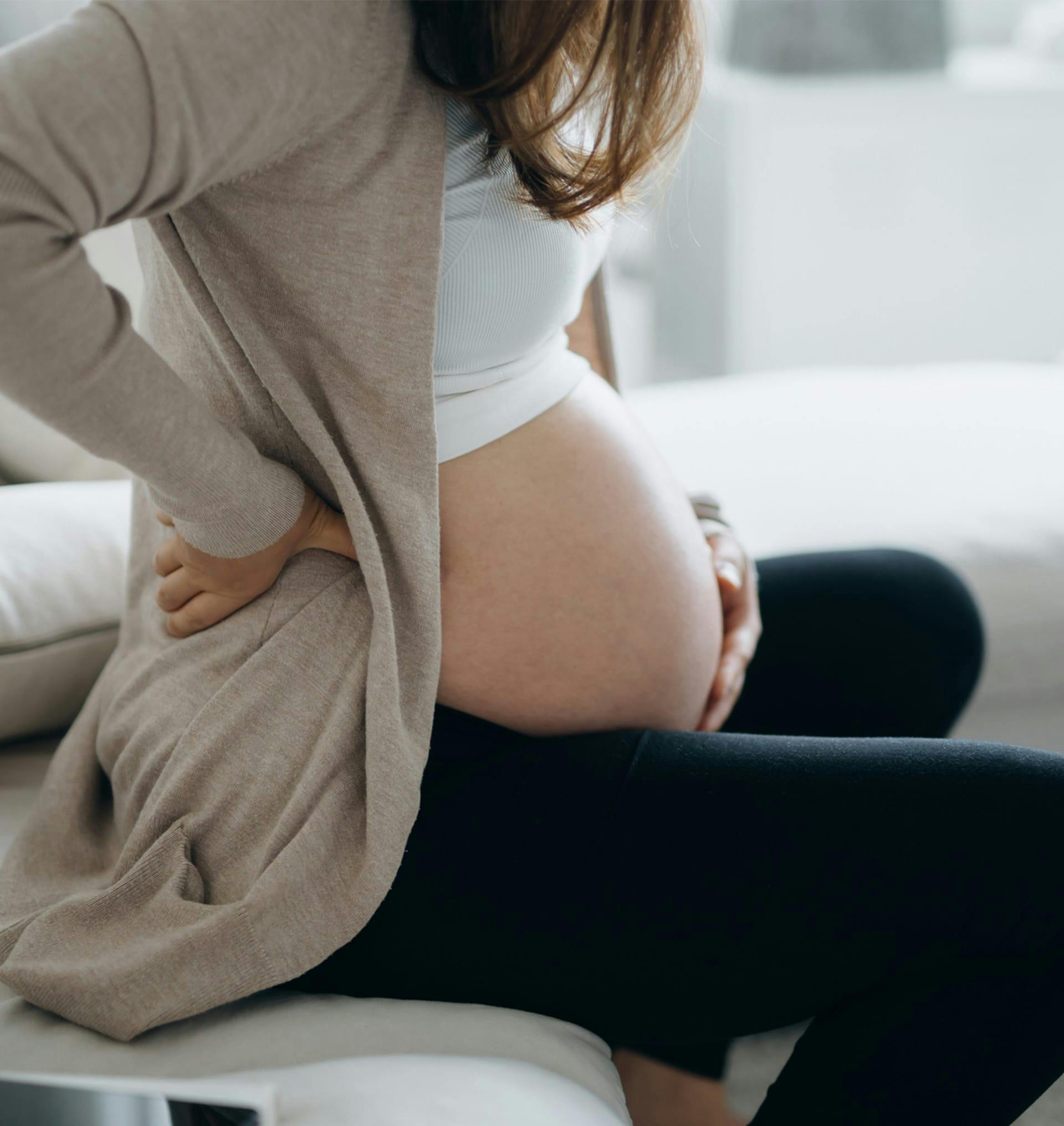 pregnant woman holding her belly