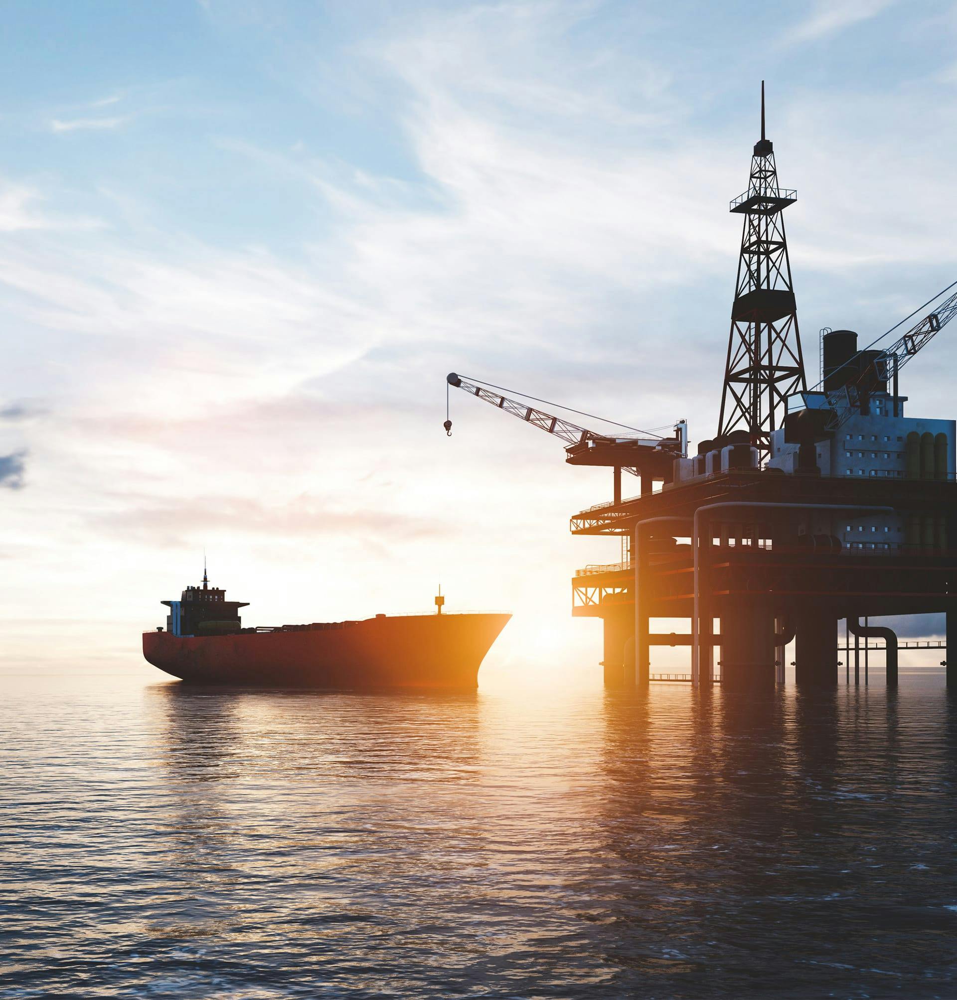 oil platform and ship at sunset