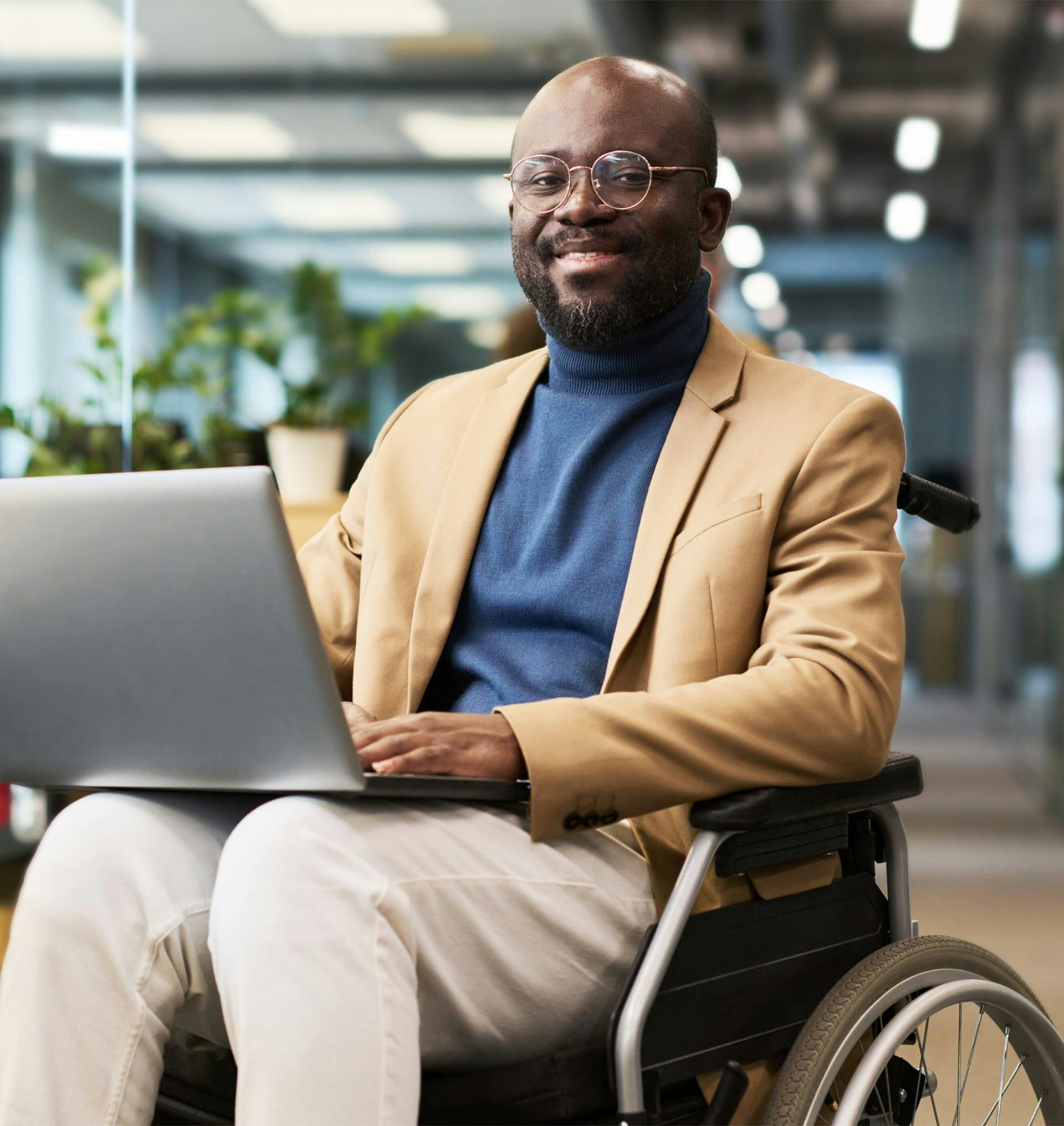 man in wheelchair with a laptop