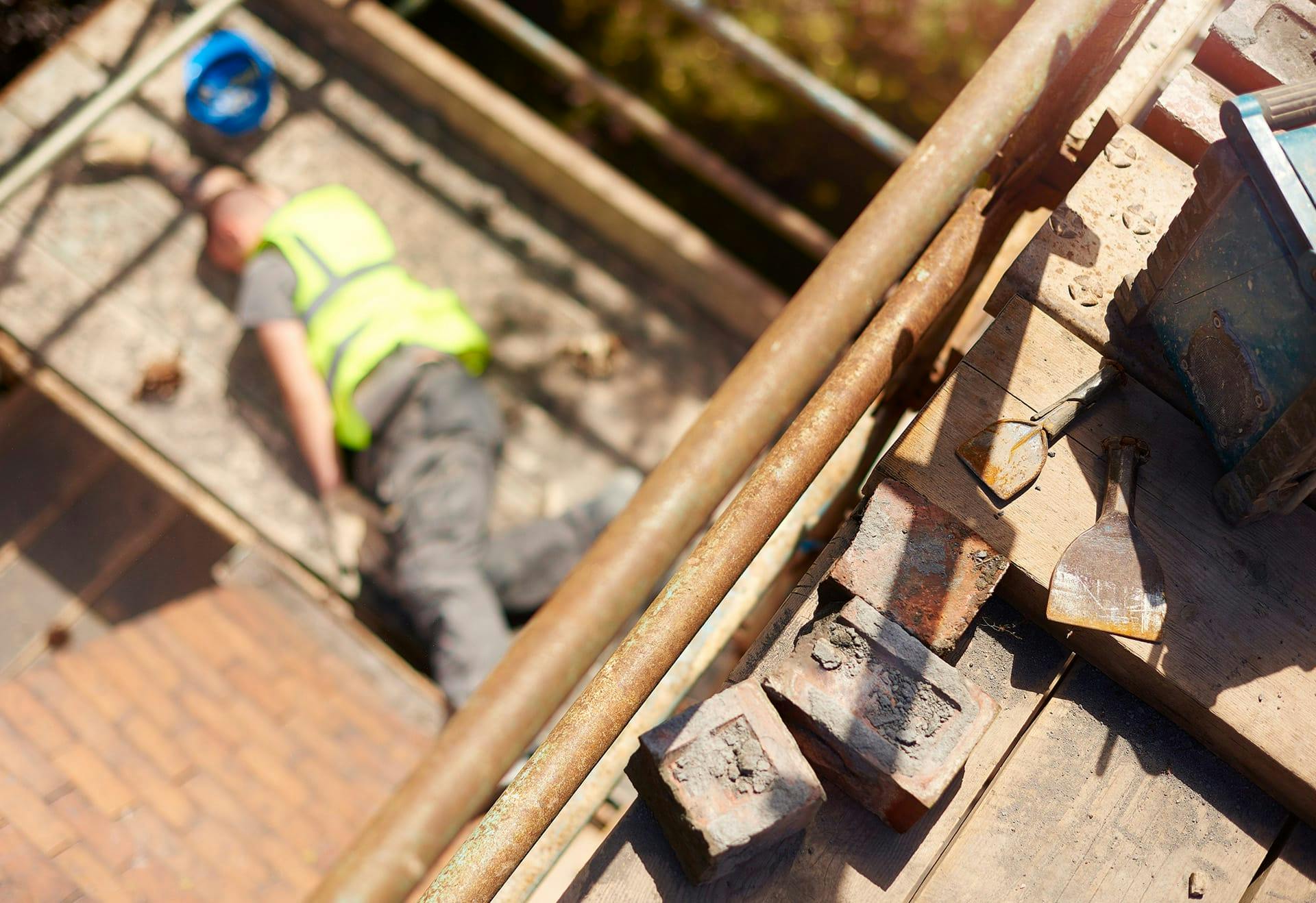 construction worker lying unconscious