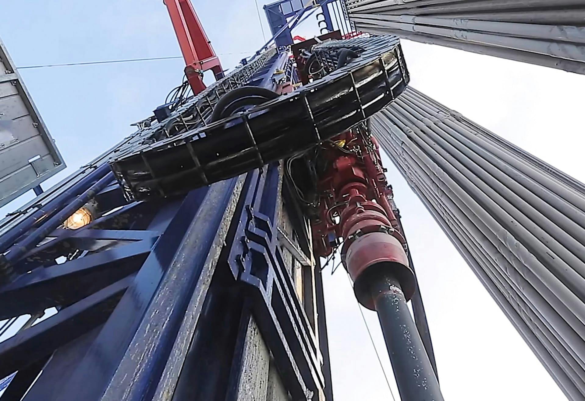 view looking up at an oil derrick
