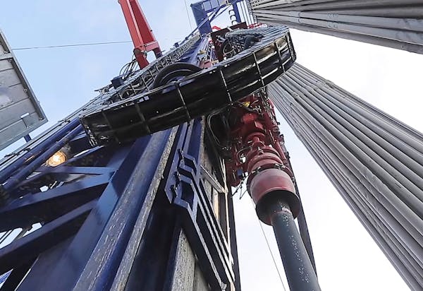 view looking up at an oil derrick