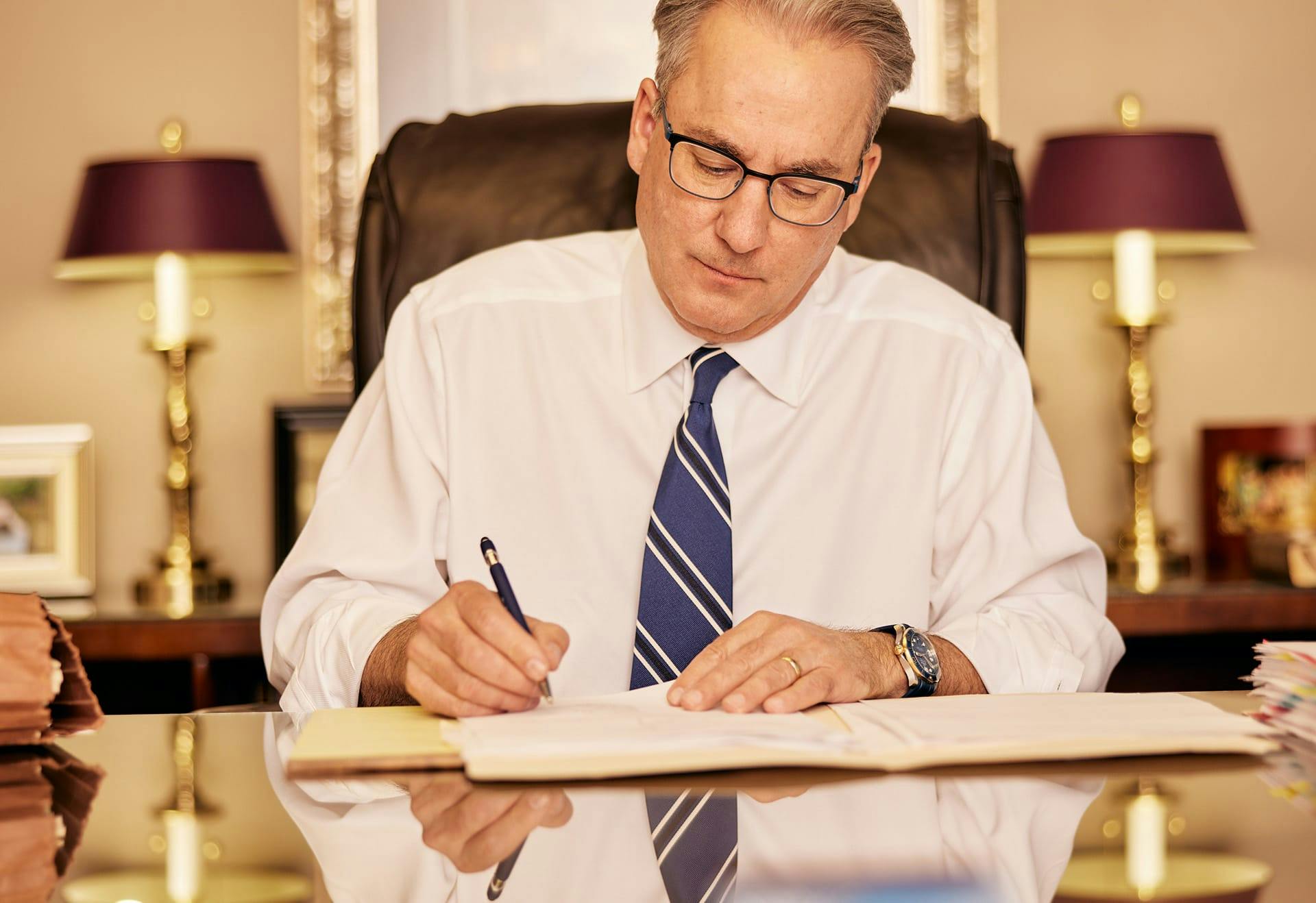 James Belote writing in book