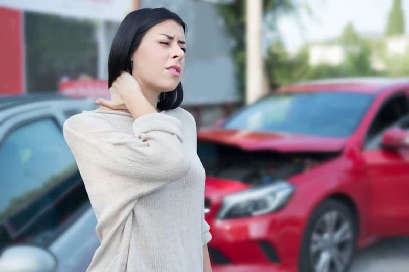 A woman rubbing her neck