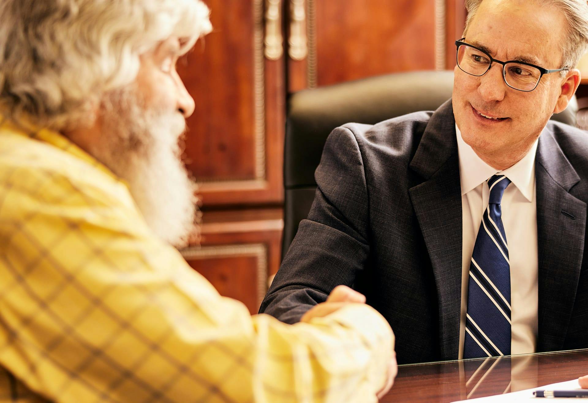 James Belote shaking a client's hand.
