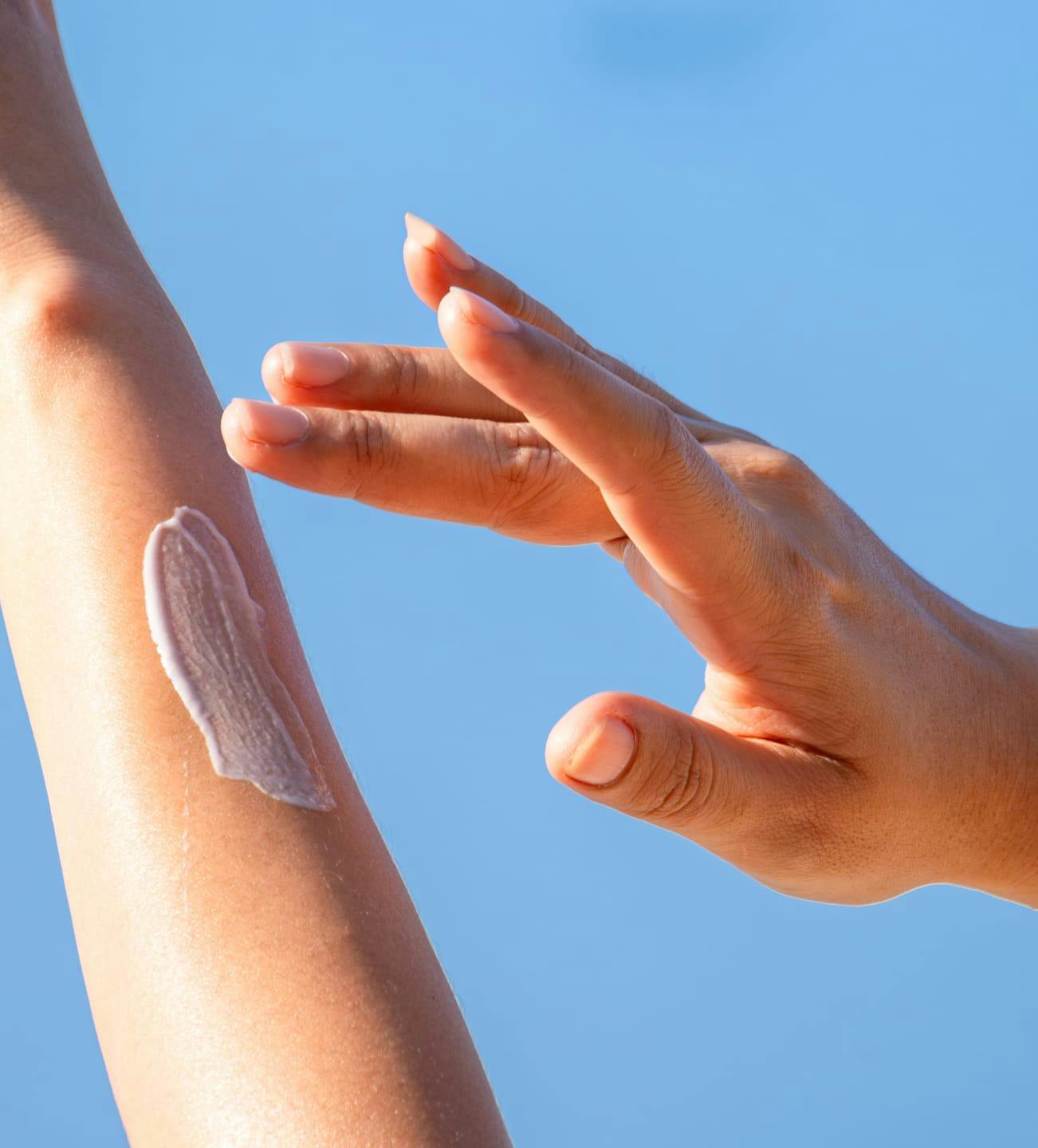 person wiping product on their arm