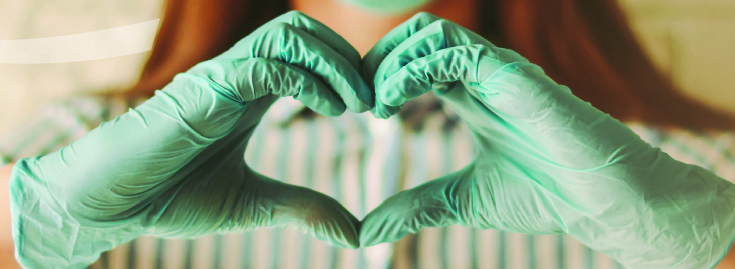 gloved hands making a heart