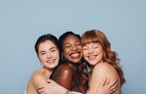 group of women smiling and hugging