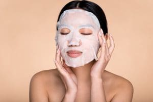 woman wearing a sheet mask