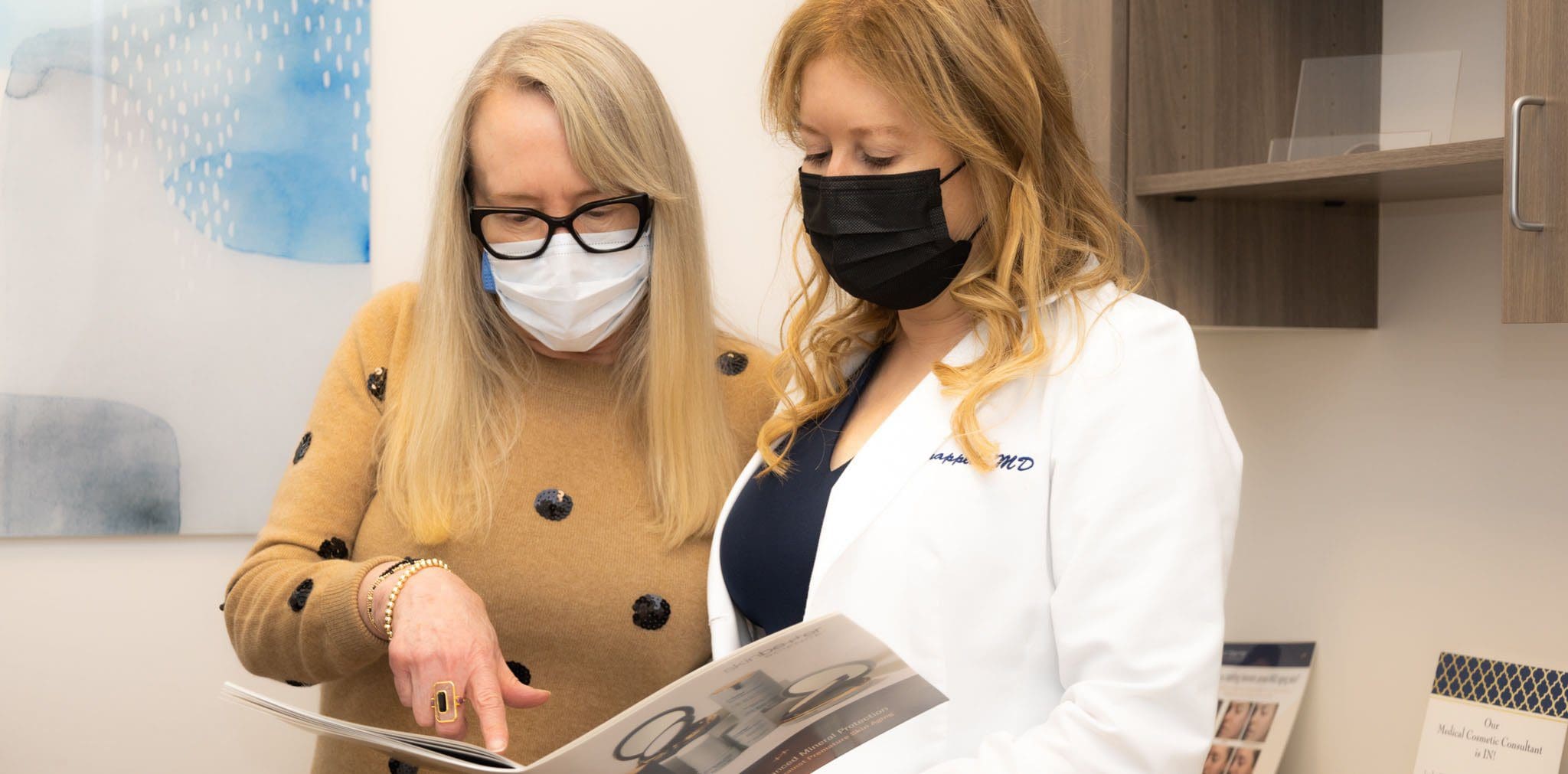 two women looking at a brochure