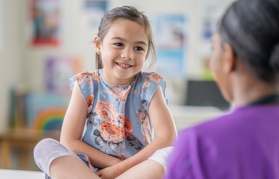 Child smiling at nurse