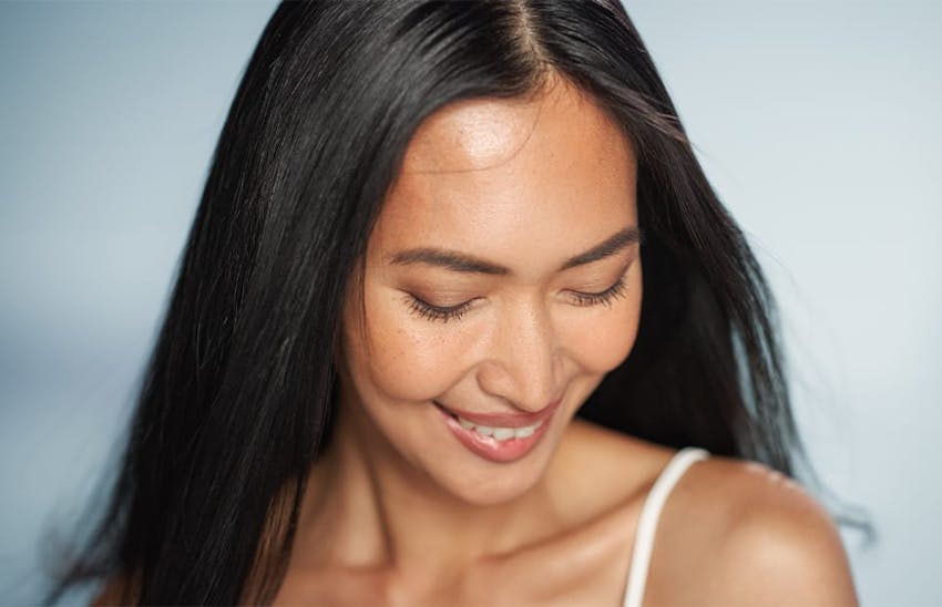 Woman smiling and looking at her shoulder