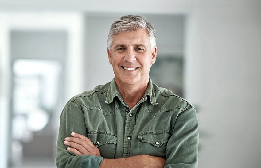 Man smiling with his arms crossed