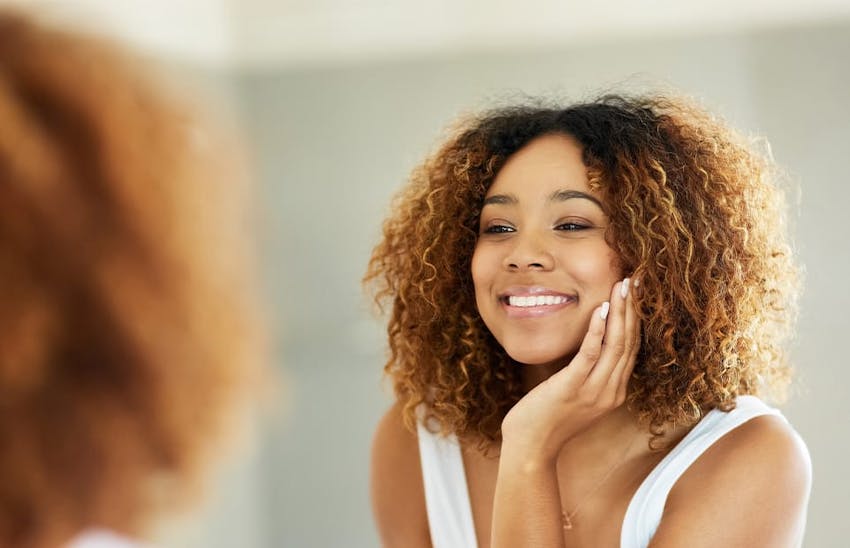 Woman smiling into the mirror