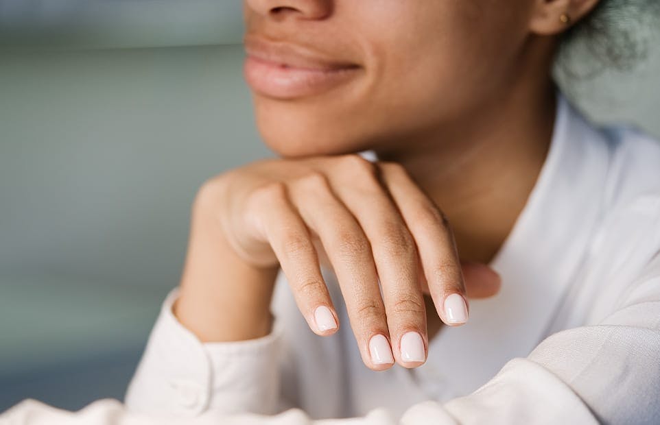 Woman's chin resting on her hand