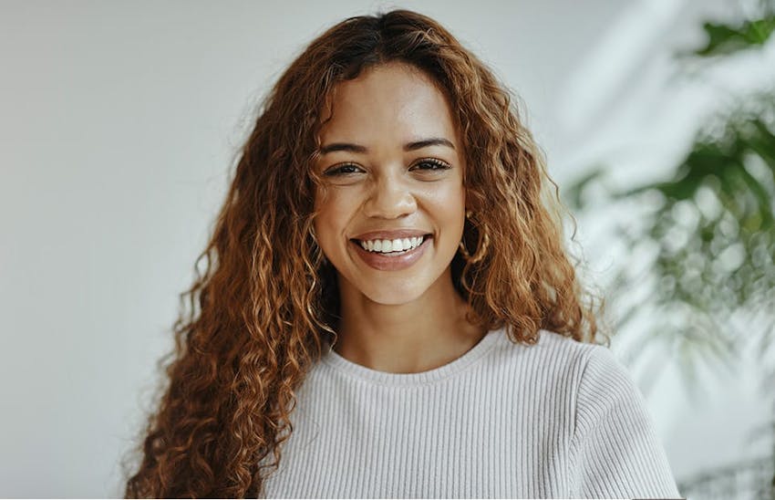 Smiling woman with long wavy hair