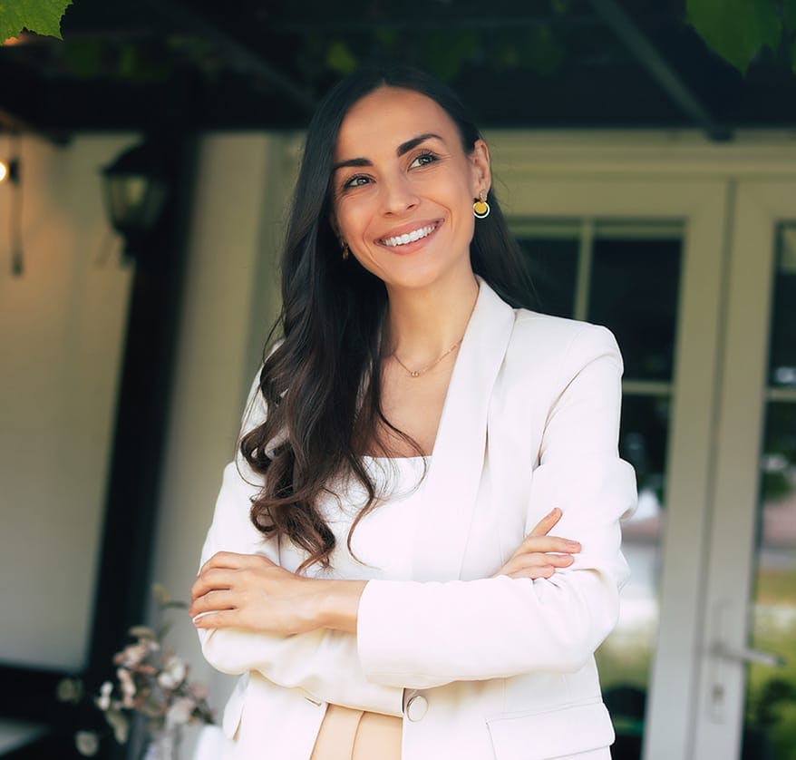 Woman in white blazer smiling
