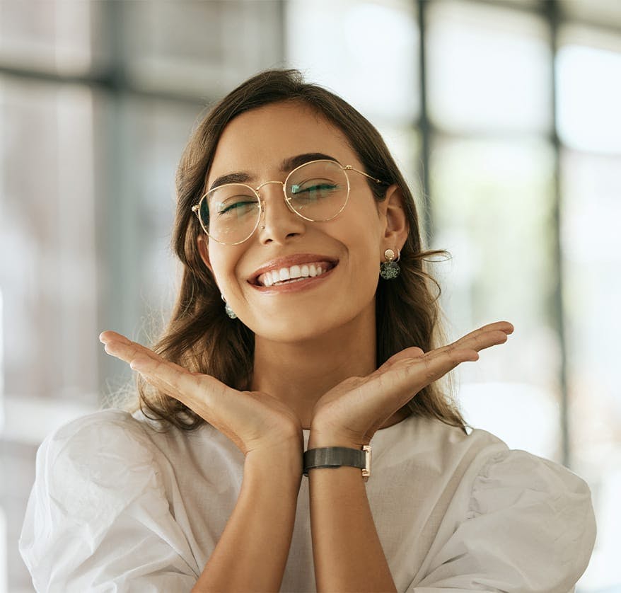 Woman smiling and framing face with hands