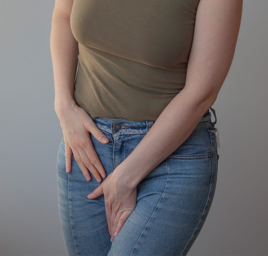 Woman holding inner thigh