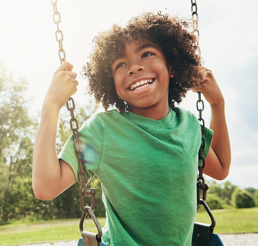 Child playing on swing