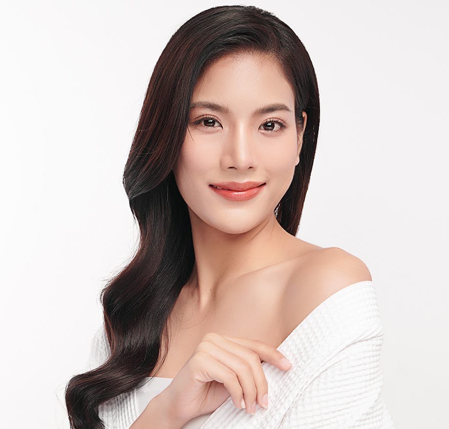 Woman in white robe smiling