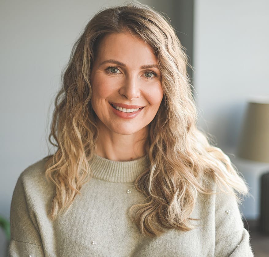 Woman with light brown hair smiling
