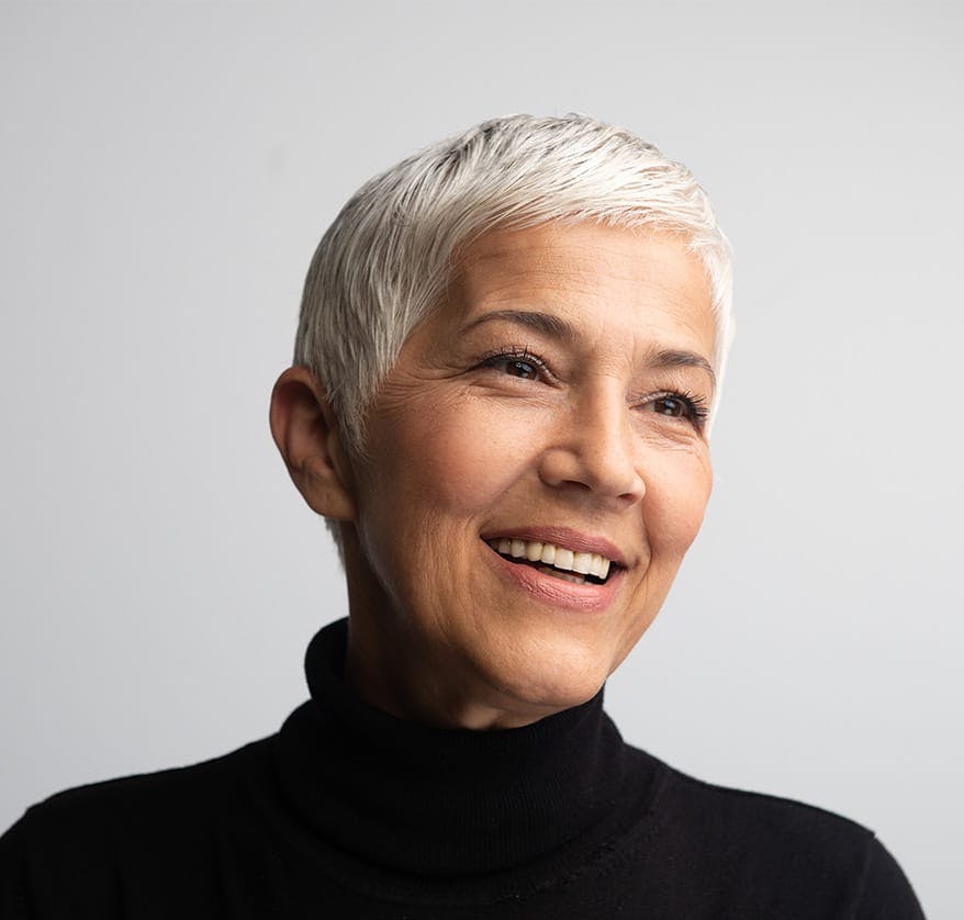 Woman smiling in black turtleneck