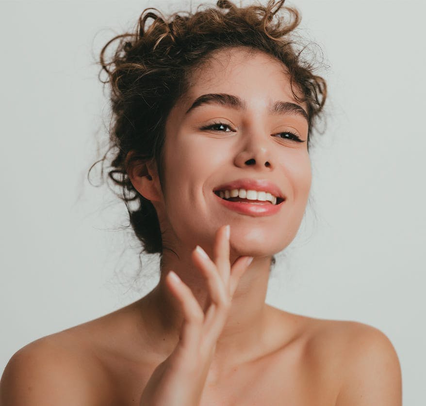 Woman smiling and touching her chin