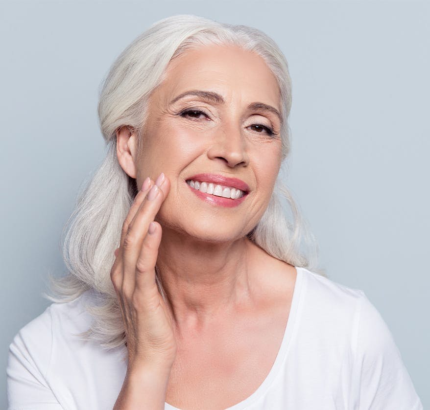 Woman smiing and touching her cheek