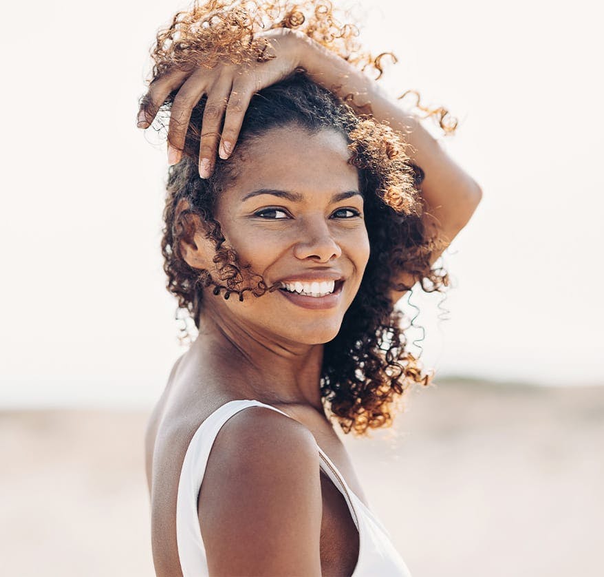 Woman brushing hair out of her face