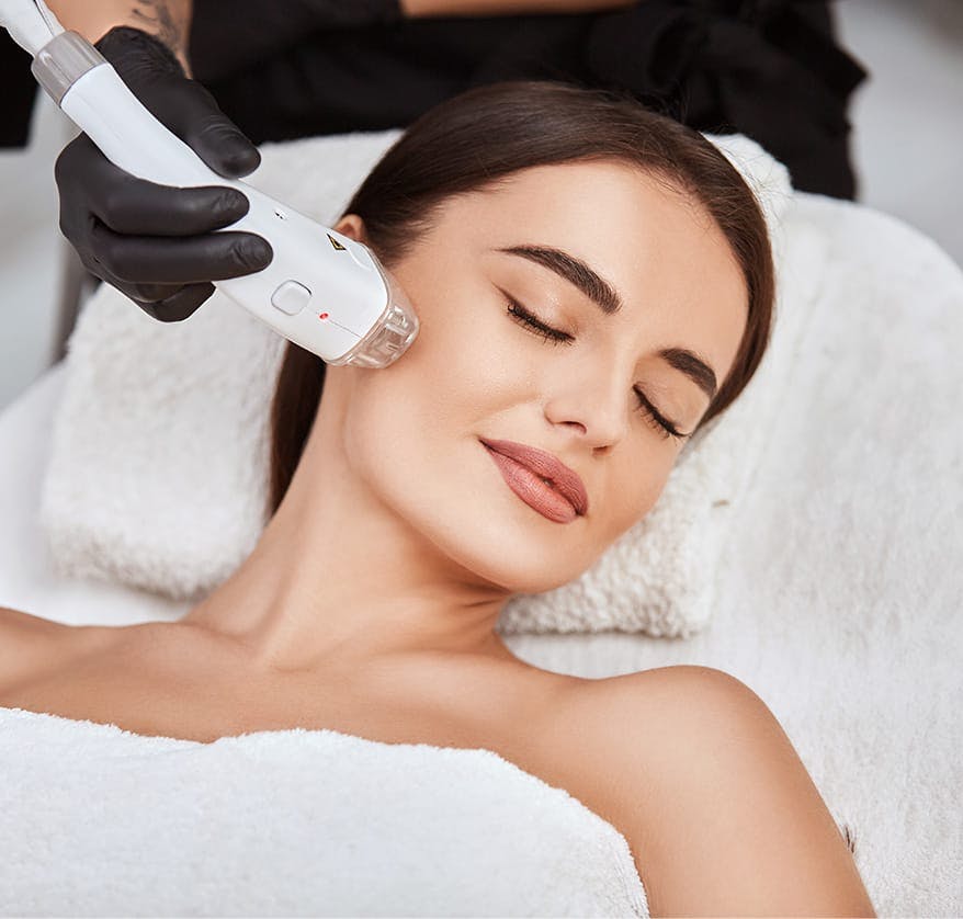 Woman receiving microneedling treatment