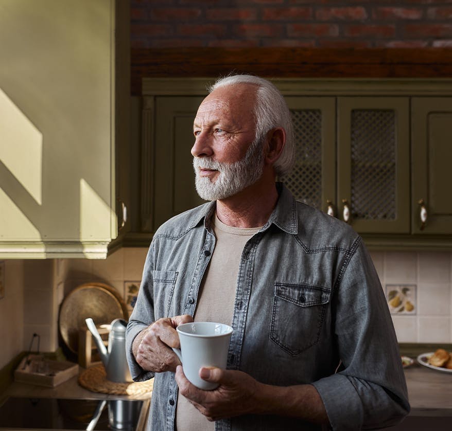 Bearded man holding mug